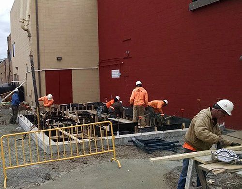 a group of construction workers are working on a construction site
