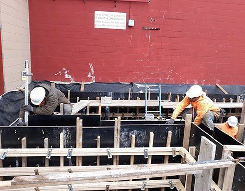 a group of construction workers are working on a construction site