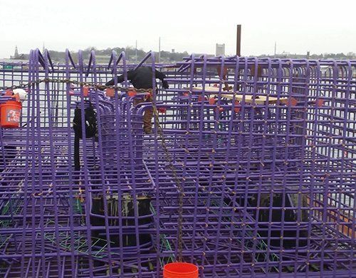 a purple cage with a red bucket in it