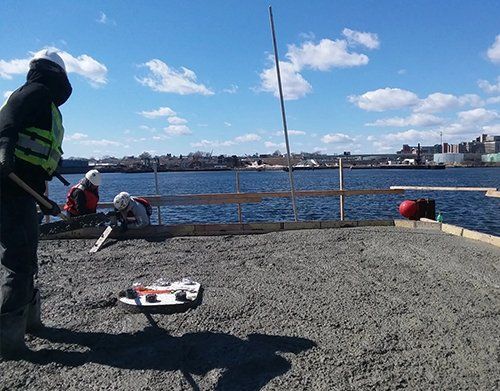 a man is standing in front of a body of water
