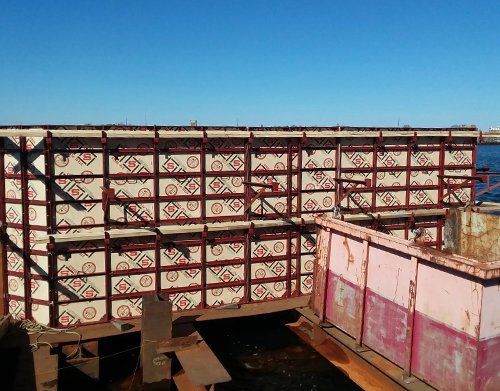 a large red and white structure with a blue sky in the background
