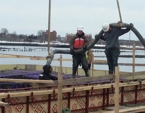 a man is holding a hose with the letter s on it