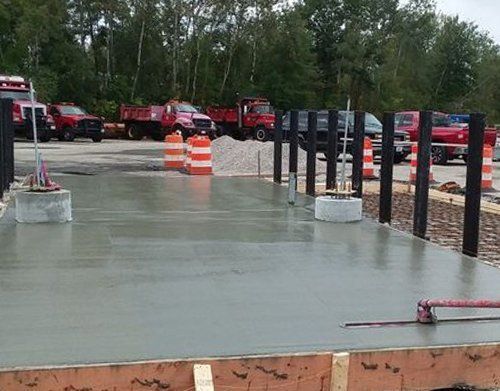 a concrete floor is being built in a parking lot