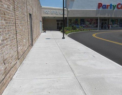 a sidewalk in front of a party city store