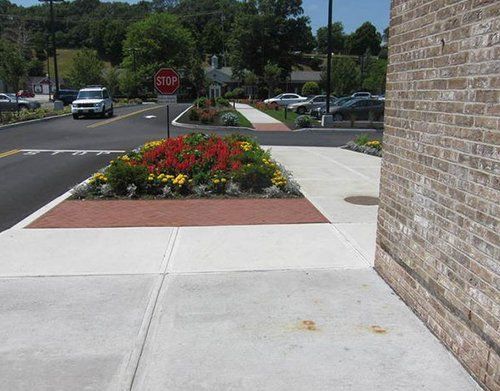 a stop sign is on the sidewalk next to a brick building