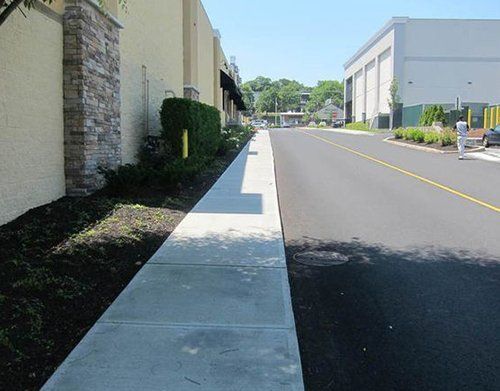 a sidewalk leading to a building next to a road