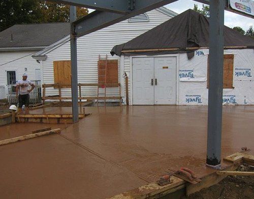 a man is standing in front of a church that is being remodeled