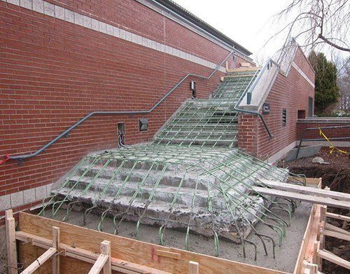a staircase is being built in front of a brick building