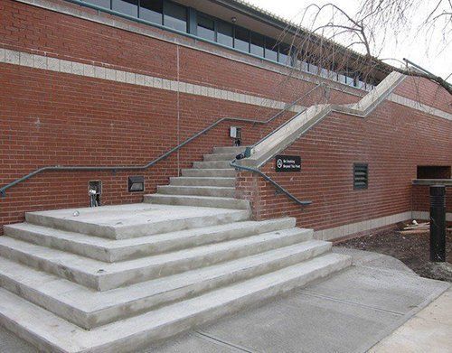 a set of stairs leading up to a brick building