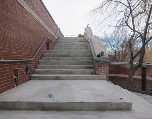 a set of stairs leading up to a brick building