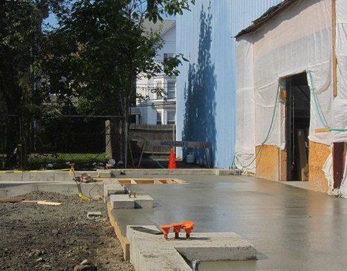 a construction site with a blue building in the background