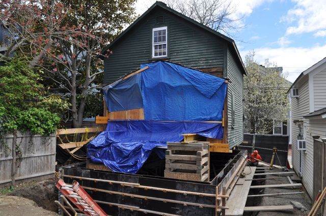 a blue tarp is covering a house for concrete construction