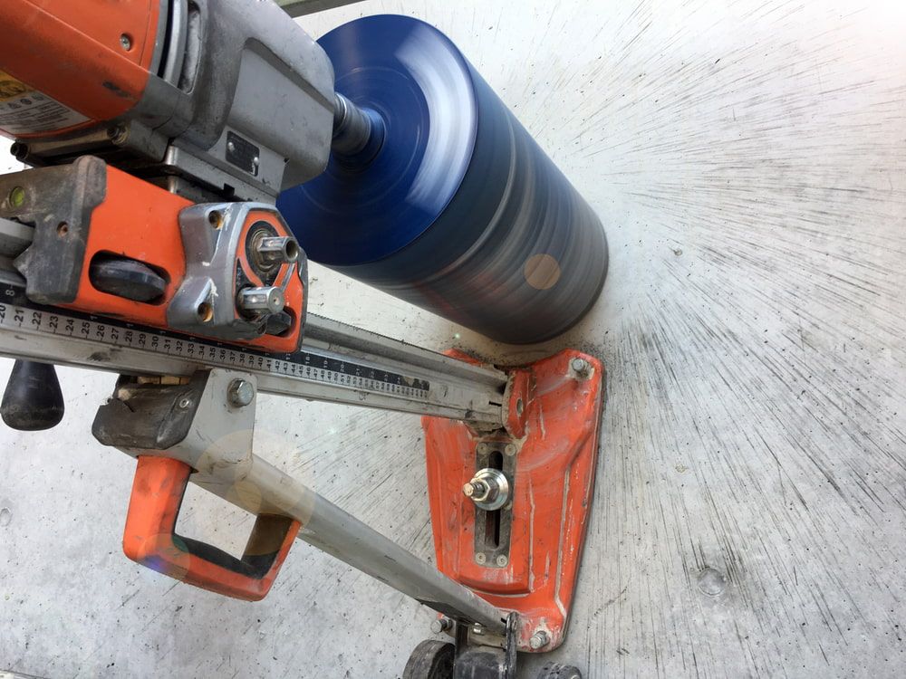 A Machine Is Cutting A Hole In A Concrete Wall — Pro Cut N Core In Manunda, QLD