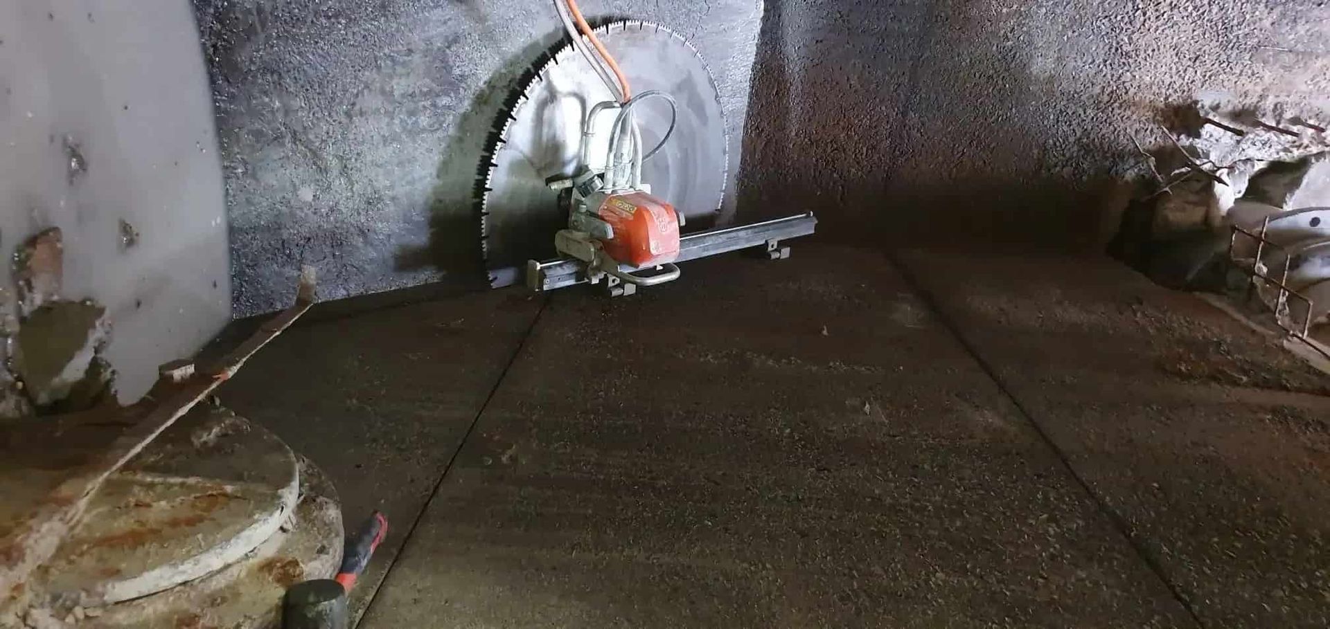 A Circular Saw Is Cutting A Hole In A Wall — Pro Cut N Core In Manunda, QLD
