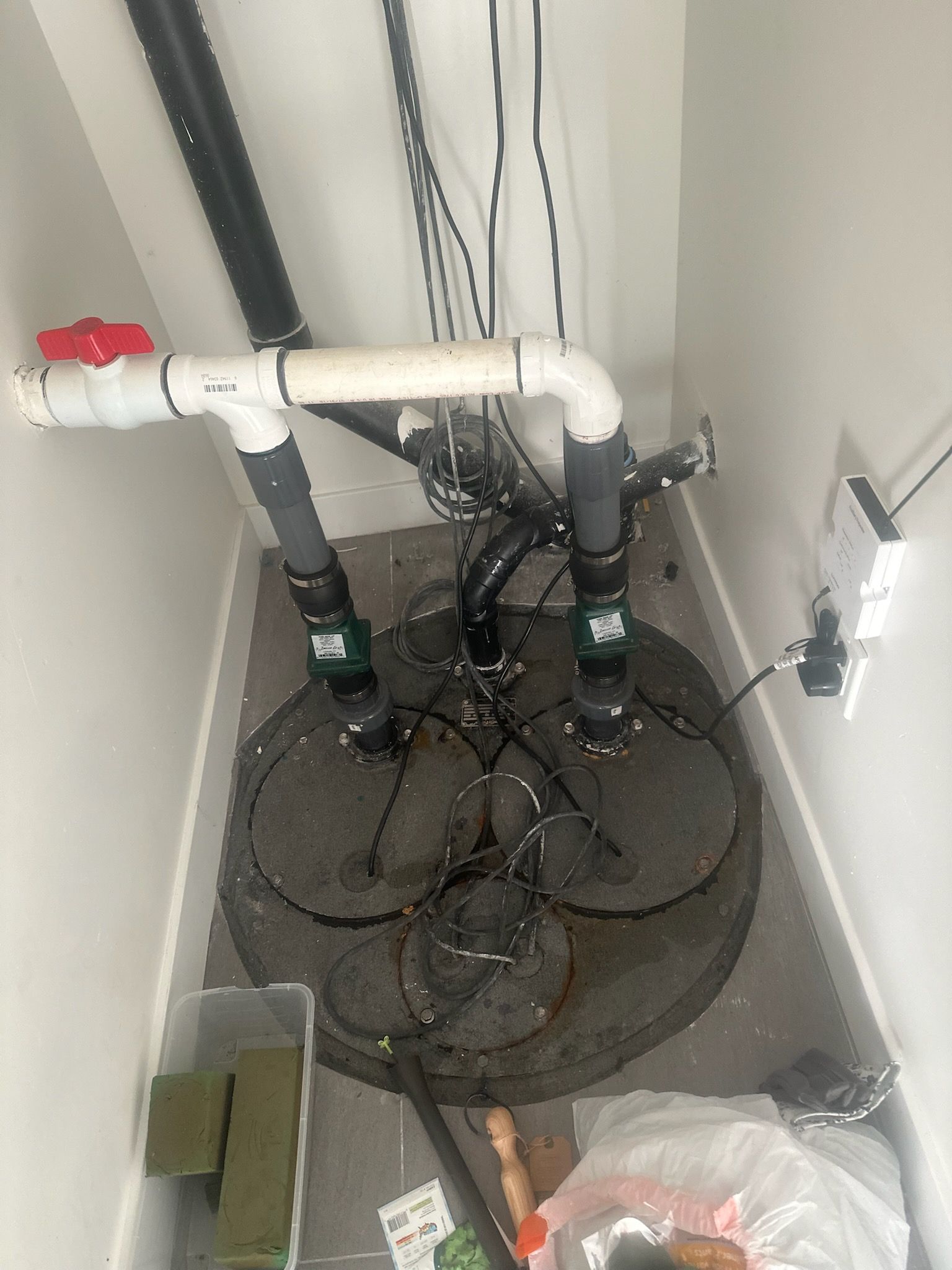 A basement with a lot of pipes coming out of it.