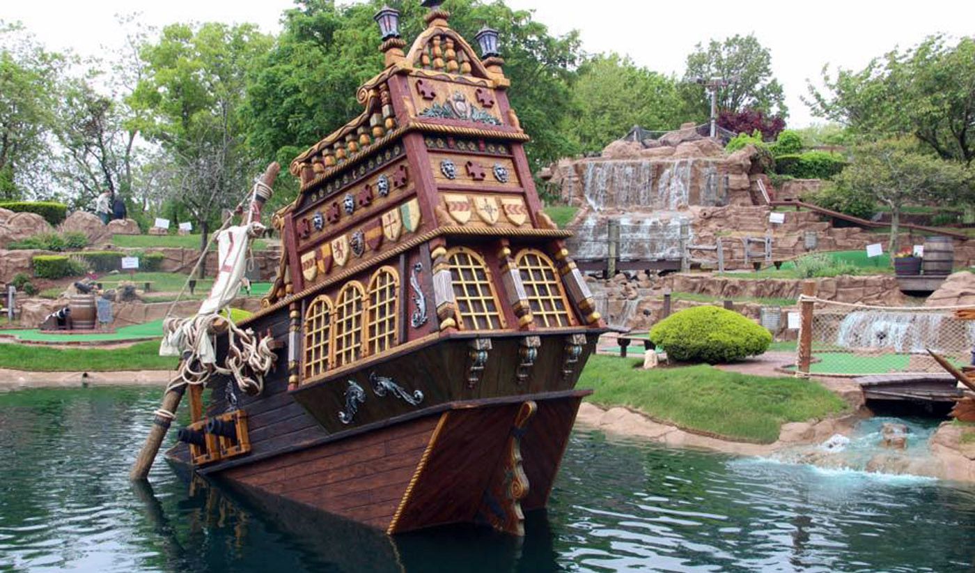 A pirate ship is floating on top of a body of water.