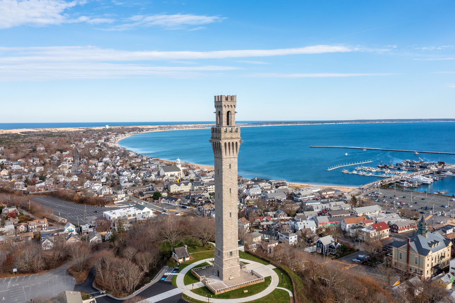 An aerial view of a tower overlooking a city and the ocean.