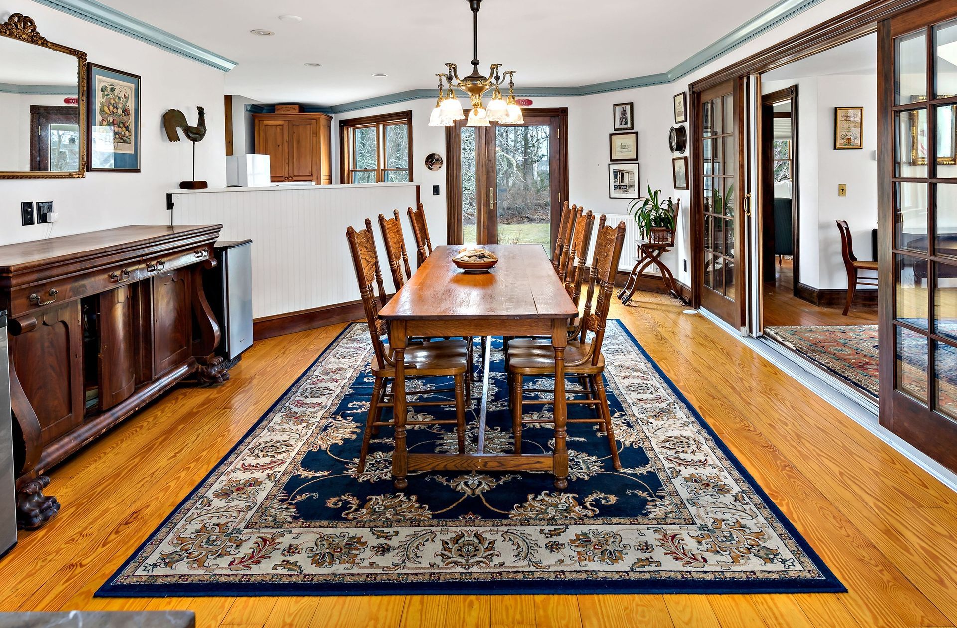 A large dining room with a wooden table and chairs