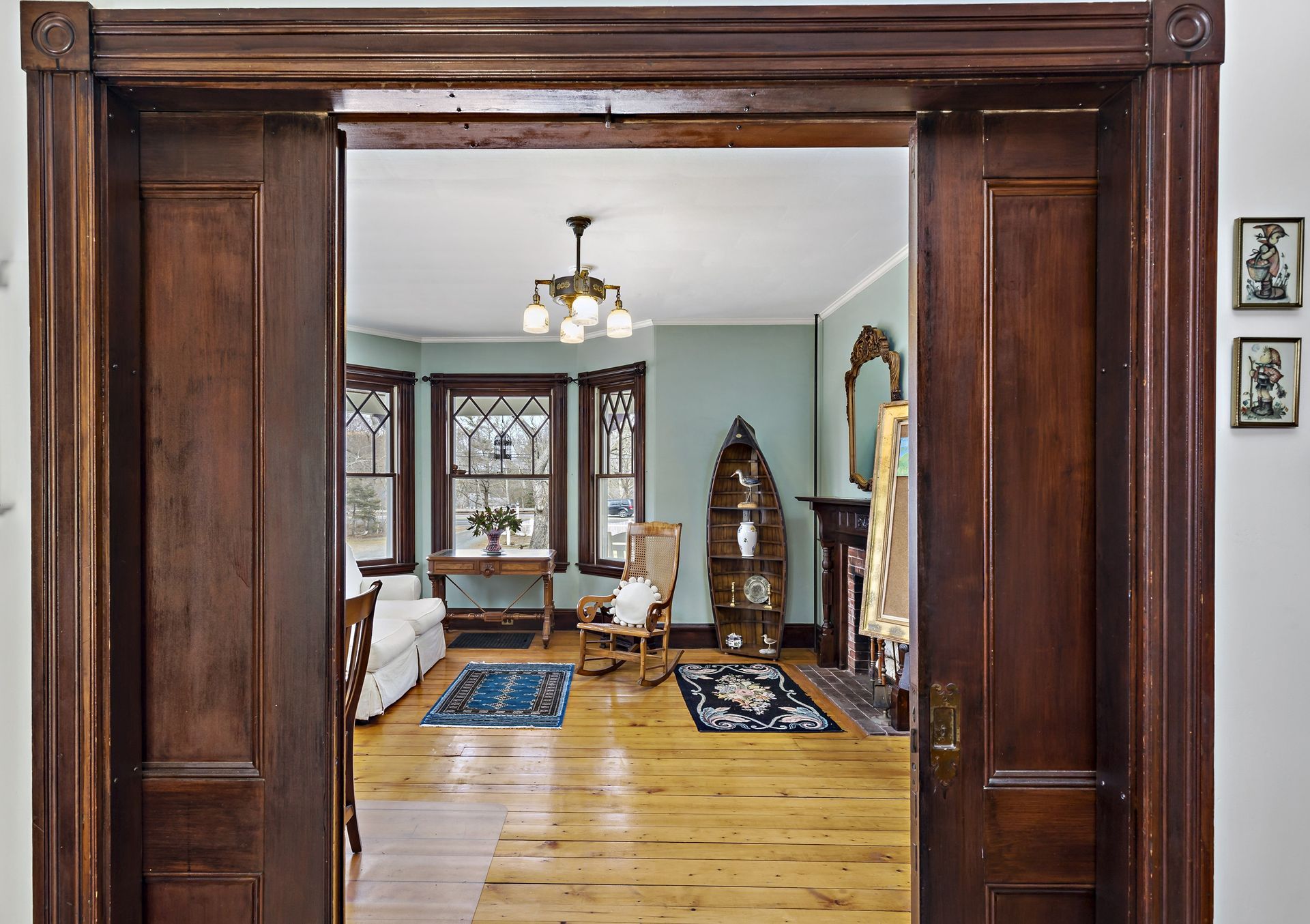 A view of a living room through a wooden door.
