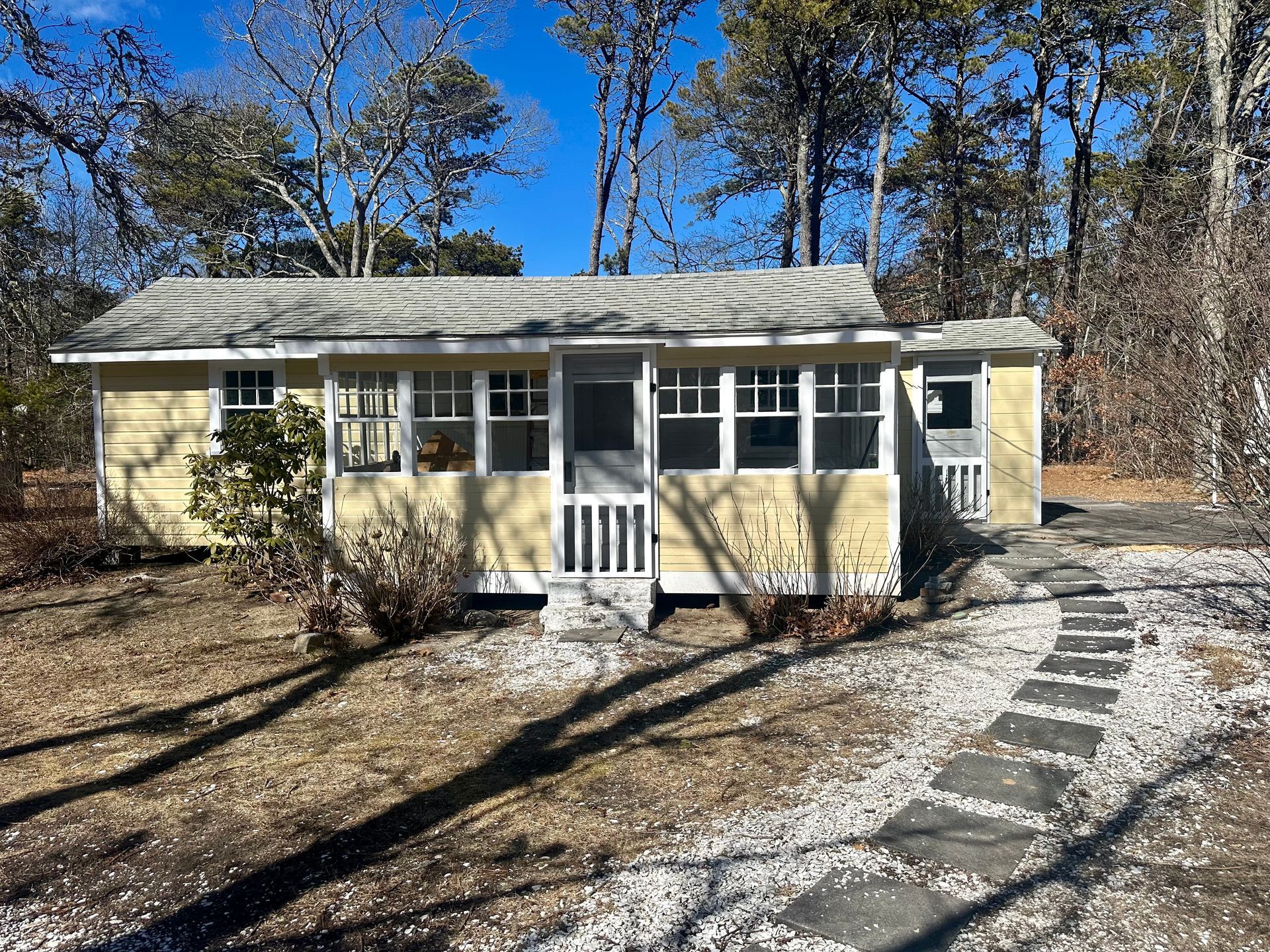 A white house with an american flag on the porch