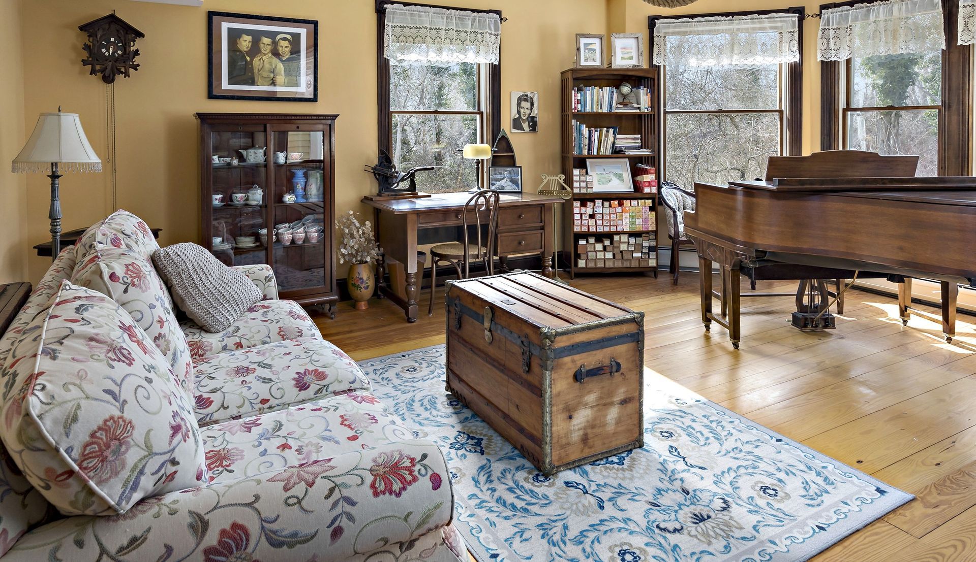 A living room with a couch and a piano
