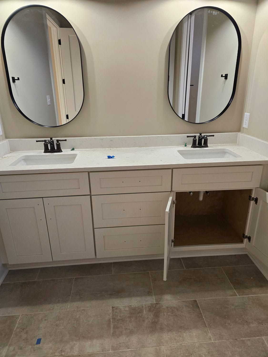 A bathroom with two sinks and two mirrors.