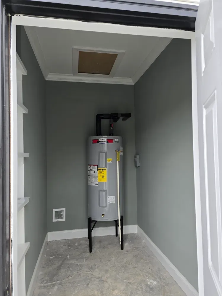 A small room with a water heater in it.