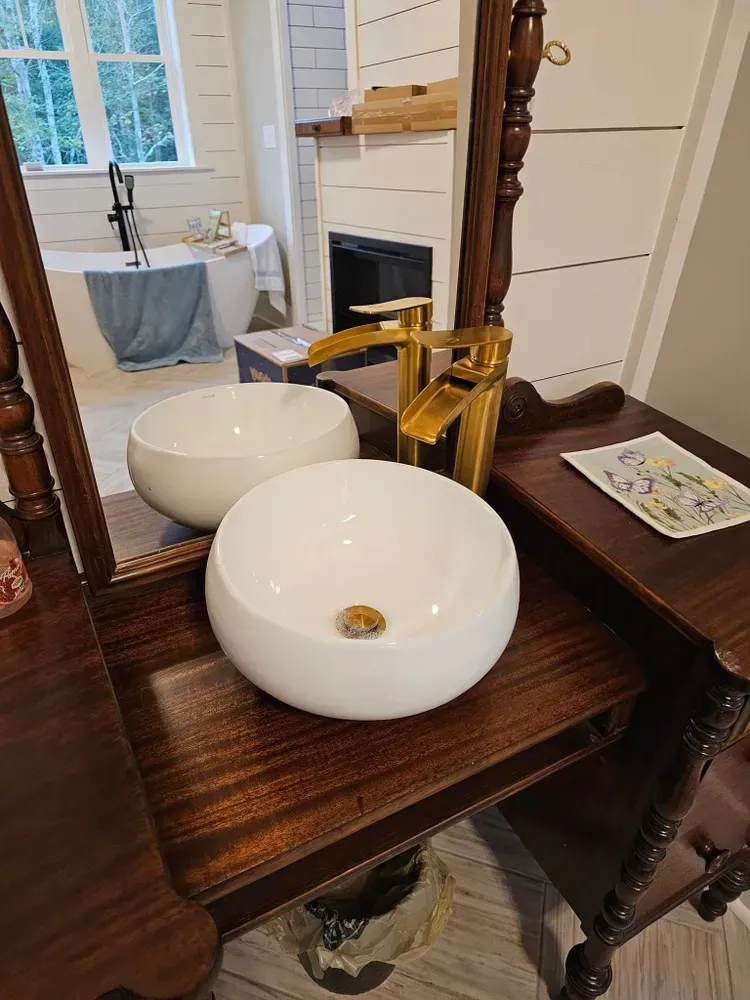 A bathroom with two sinks and a mirror.