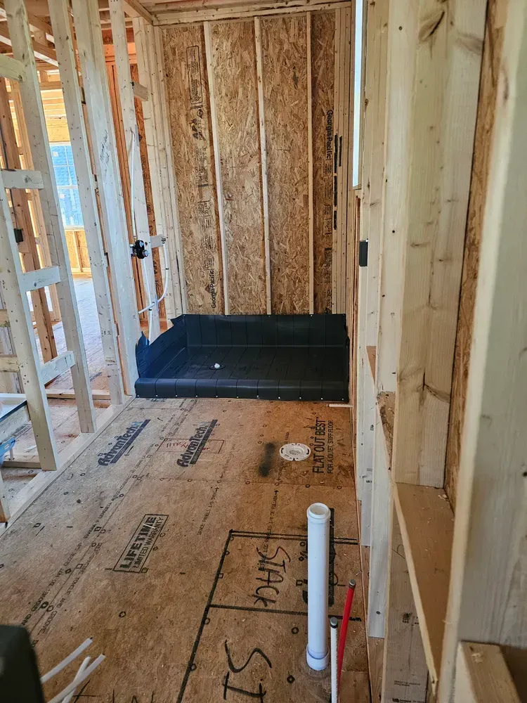 A room in a house under construction with a shower in it.
