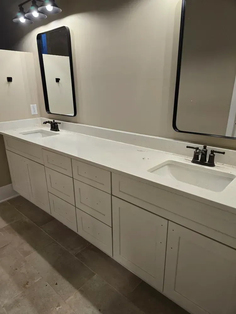 A bathroom with two sinks and two mirrors.
