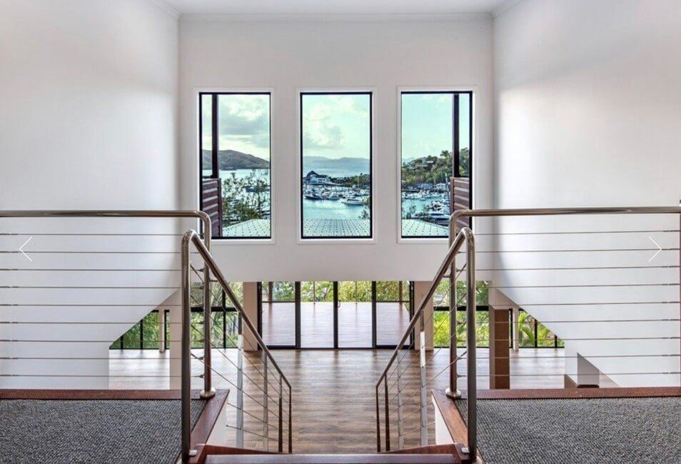 A Staircase Leading Up to the Second Floor of a House — Coral Coast Building & Management in Cannon Valley, QLD