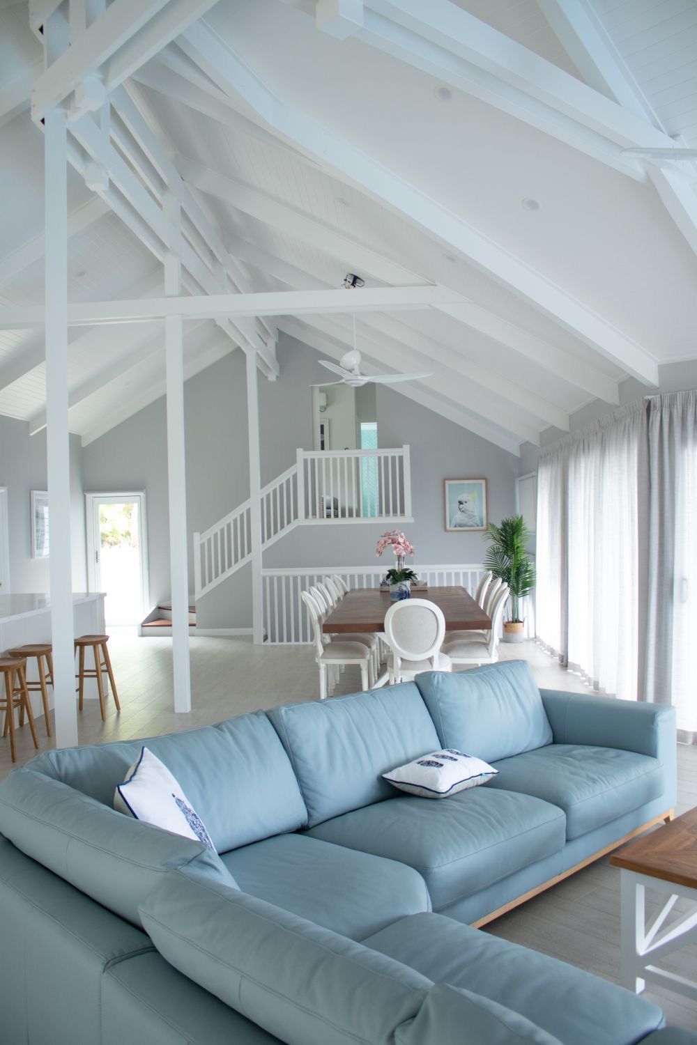 A Living Room With a Blue Couch and White Beams — Coral Coast Building & Management in Cannon Valley, QLD