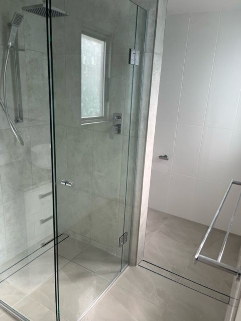 A Bathroom With a Walk in Shower and a Window — Coral Coast Building & Management in Cannon Valley, QLD