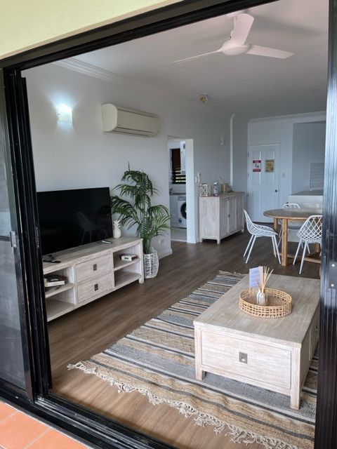 A Living Room With a Flat Screen Tv and a Coffee Table — Coral Coast Building & Management in Cannon Valley, QLD