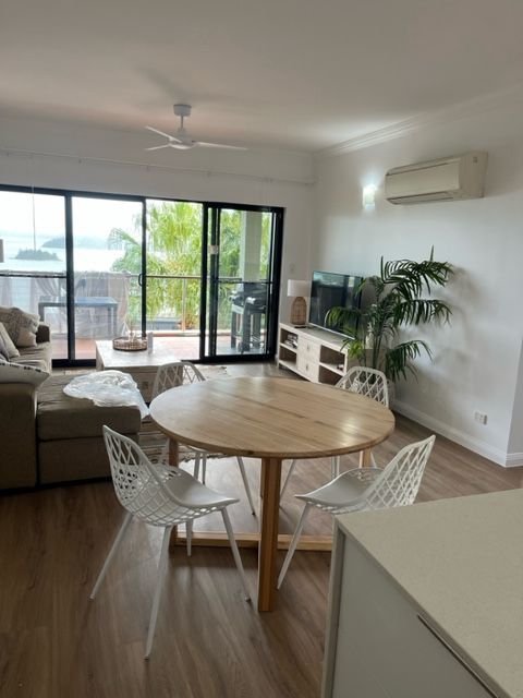 A Living Room With a Round Table and Chairs — Coral Coast Building & Management in Cannon Valley, QLD