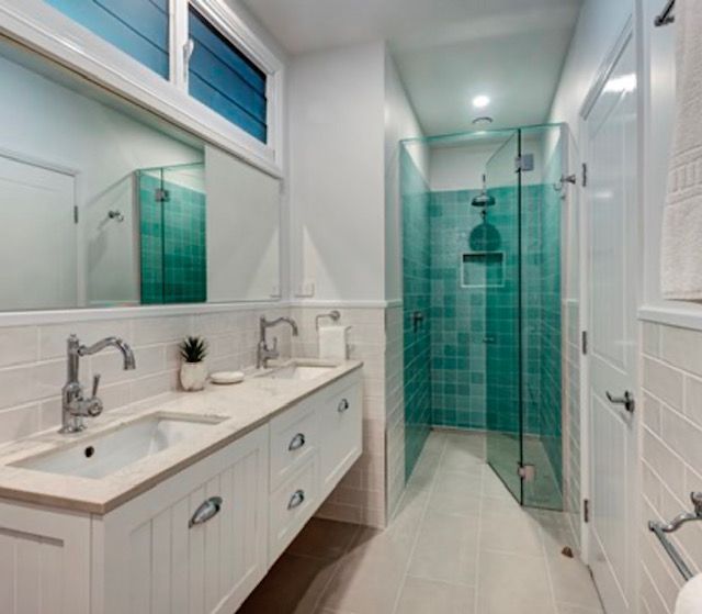 A Bathroom With Two Sinks and a Walk in Shower — Coral Coast Building & Management in Cannon Valley, QLD