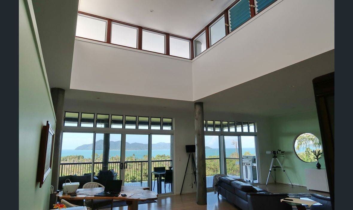 A Living Room With a Lot of Windows and a Balcony — Coral Coast Building & Management in Cannon Valley, QLD