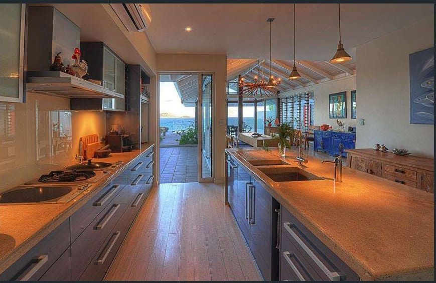 A Kitchen With a Lot of Cabinets and Counter Tops — Coral Coast Building & Management in Cannon Valley, QLD