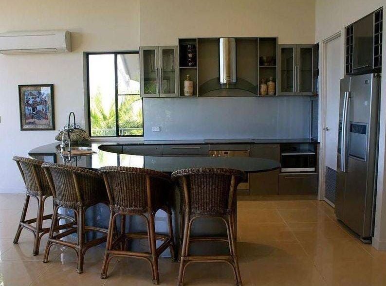 A Kitchen With a Large Island and Stools and a Refrigerator — Coral Coast Building & Management in Cannon Valley, QLD