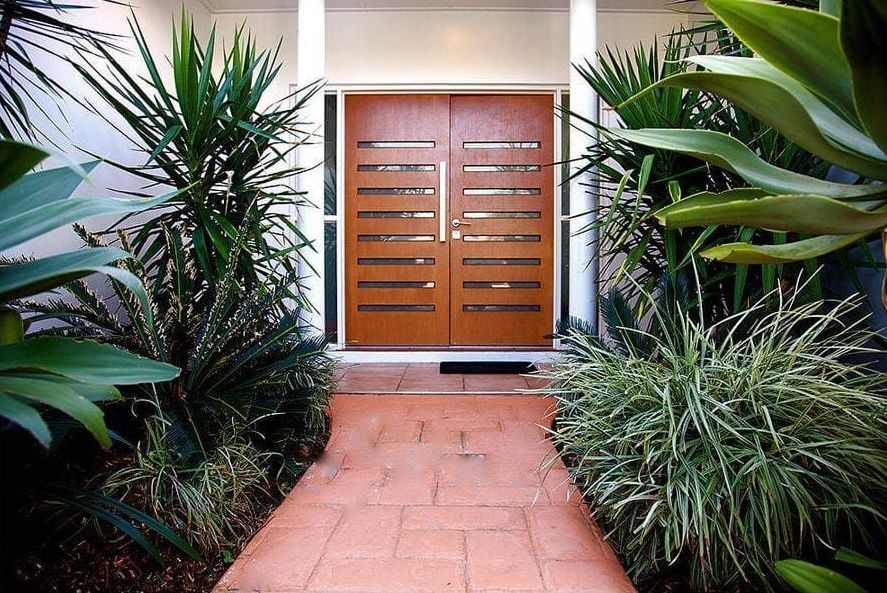A Picture of the Front Door of a House Surrounded by Plants — Coral Coast Building & Management in Cannon Valley, QLD