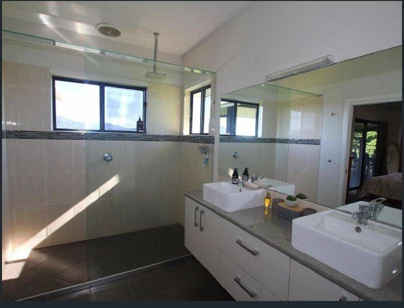 A Bathroom With Two Sinks and a Large Mirror — Coral Coast Building & Management in Cannon Valley, QLD