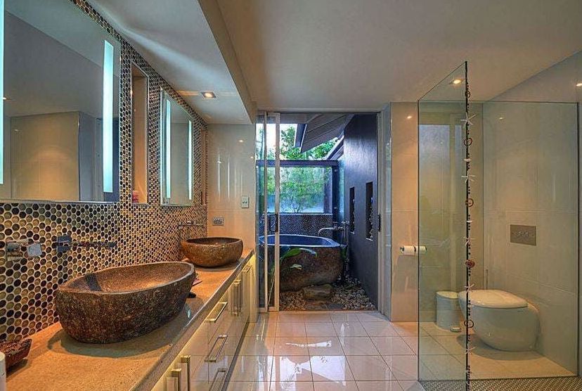 A Bathroom With Two Sinks and a Walk in Shower — Coral Coast Building & Management in Cannon Valley, QLD