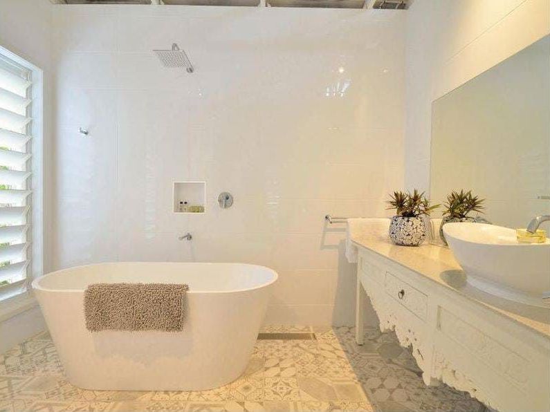 A Bathroom With a Bathtub , Sinks , Mirror and Shower — Coral Coast Building & Management in Cannon Valley, QLD