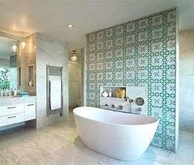 A Bathroom With a Bathtub , Sink and Mirror — Coral Coast Building & Management in Cannon Valley, QLD