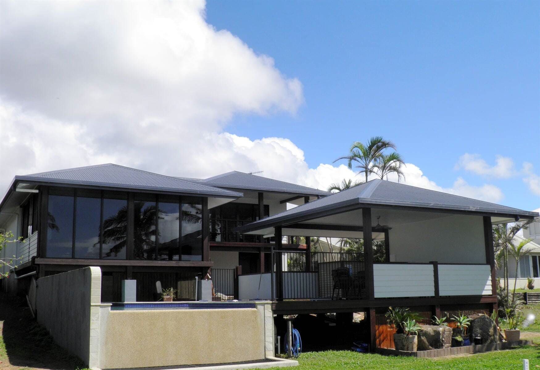 A Large House With a Lot of Windows and a Balcony — Coral Coast Building & Management in Cannon Valley, QLD