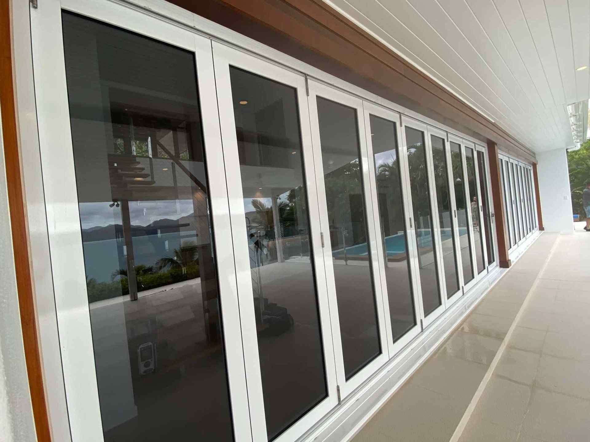 A Building With a Lot of Windows and a Pool in the Background — Coral Coast Building & Management in Cannon Valley, QLD