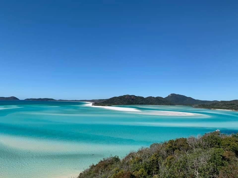A View of a Large Body of Water With Mountains in the Background — Coral Coast Building & Management in Cannon Valley, QLD