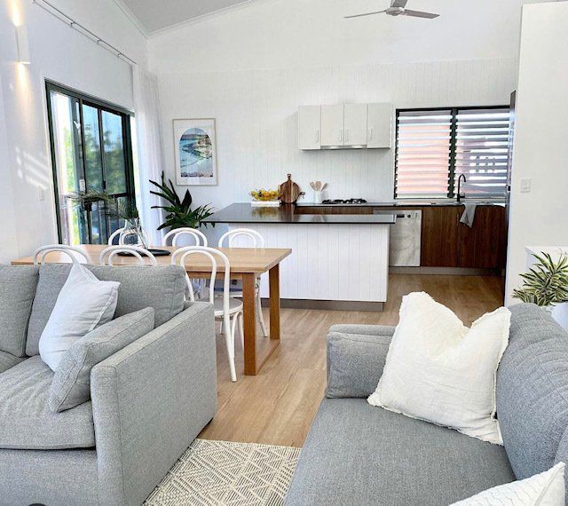 A Living Room With a Couch a Chair and a Table — Coral Coast Building & Management in Cannon Valley, QLD