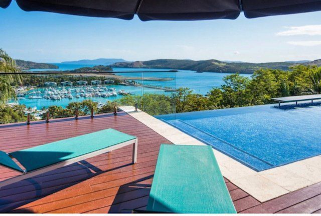 A Swimming Pool With a View of a Body of Water — Coral Coast Building & Management in Cannon Valley, QLD