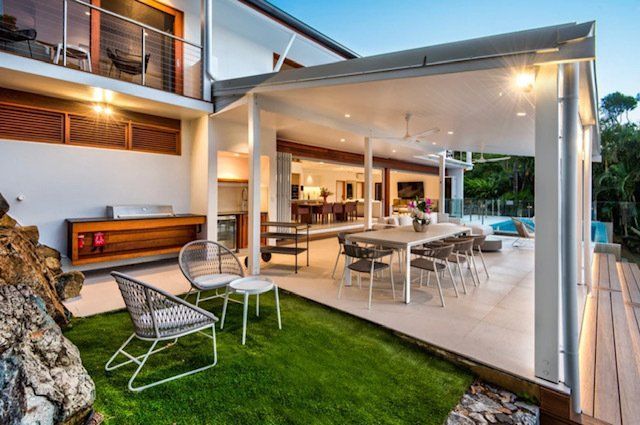 A Large House With a Large Patio Area With a Table and Chairs — Coral Coast Building & Management in Cannon Valley, QLD